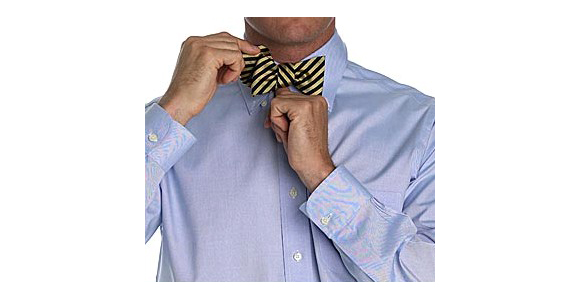 a man adjusting his tie on his collar