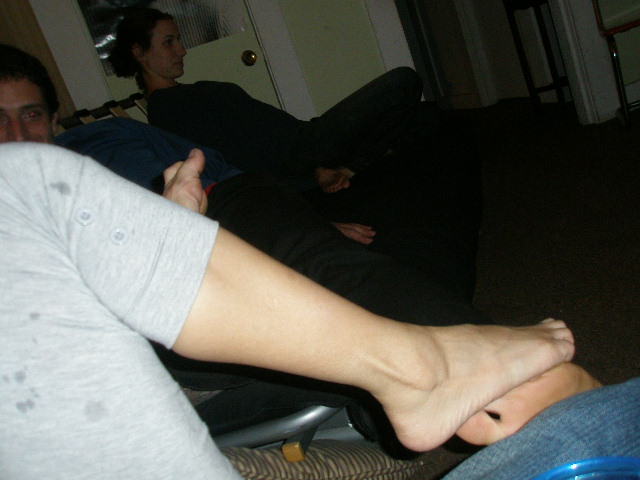three people sitting on couches with bare feet