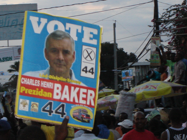 a political poster with the face of a man in white