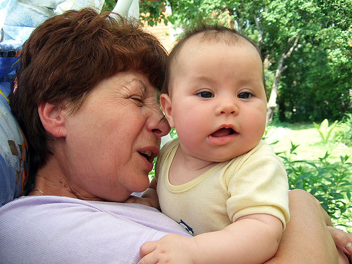 a baby with her head on a woman's shoulders