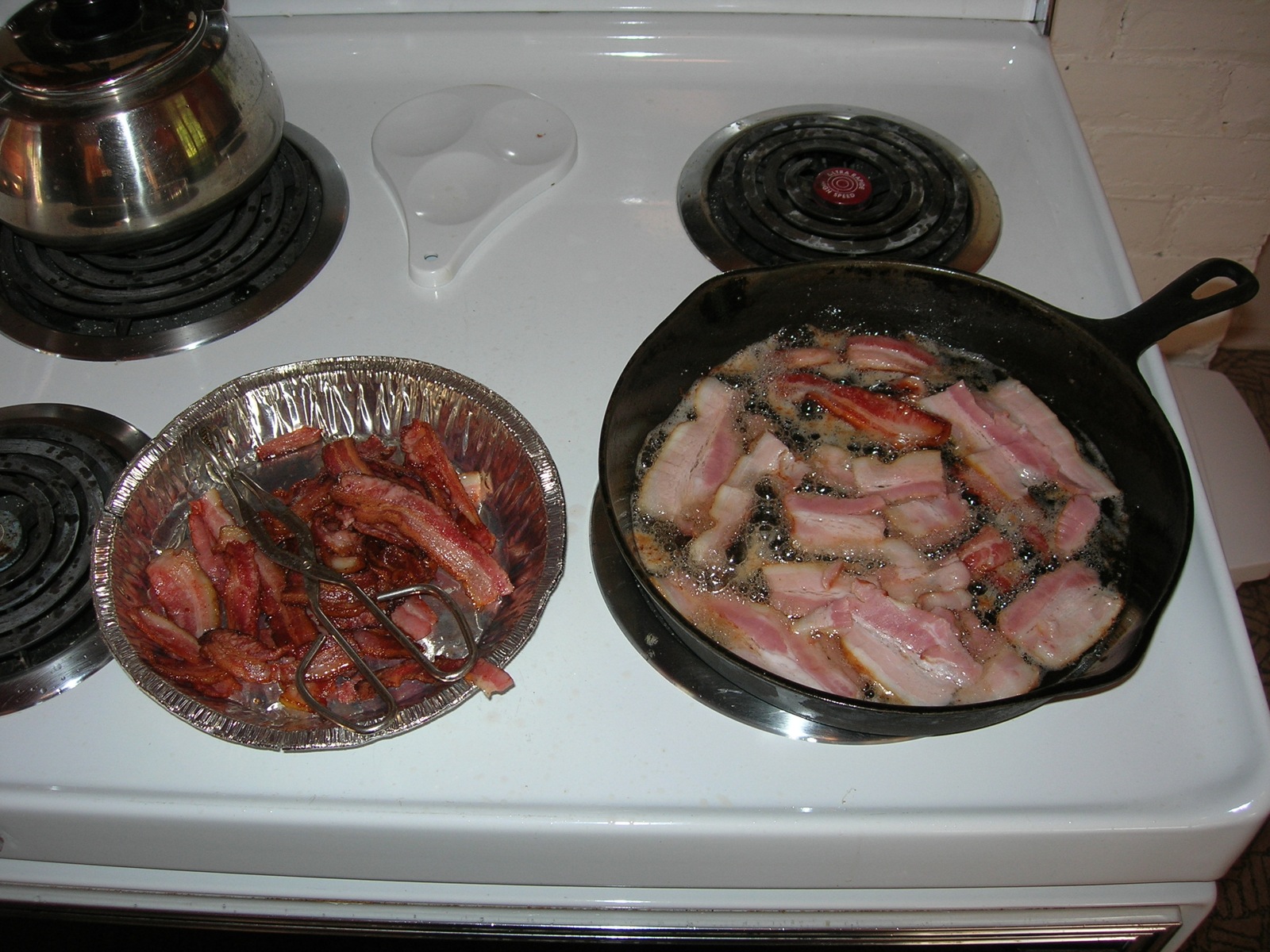 pans of raw chickens are prepared on the stove