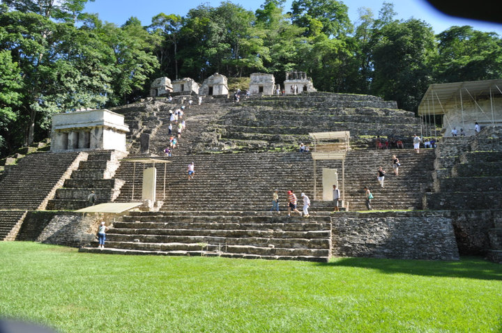 group of people walking in and around a set of stone stairs