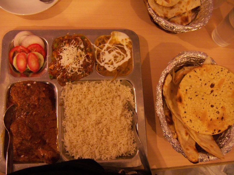 a plate of indian food sits on the table