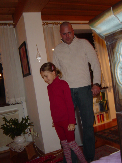 man and little girl standing next to each other in living room
