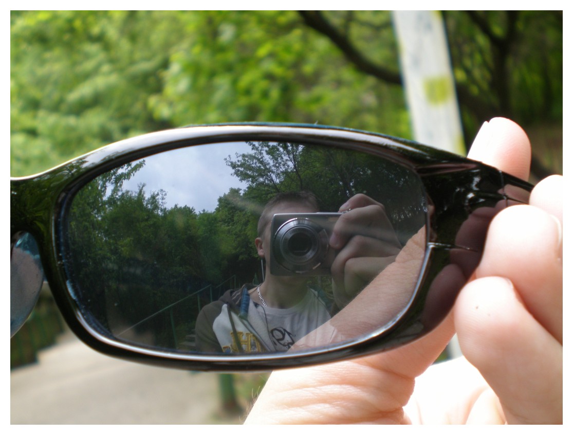 a man takes a picture through his sunglasses