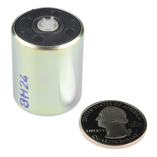 a close up of a coin and a small battery