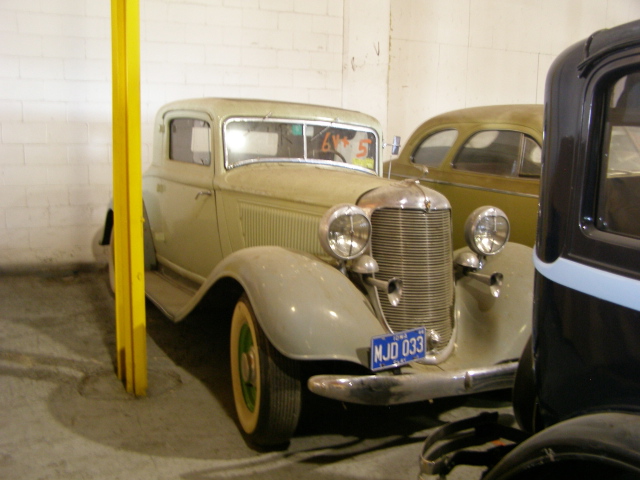 an old car that is in a garage
