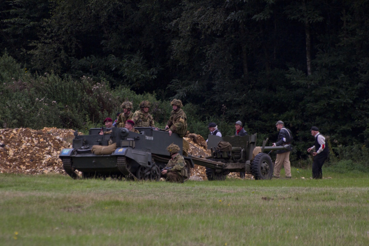 a group of men in military uniforms next to a tank