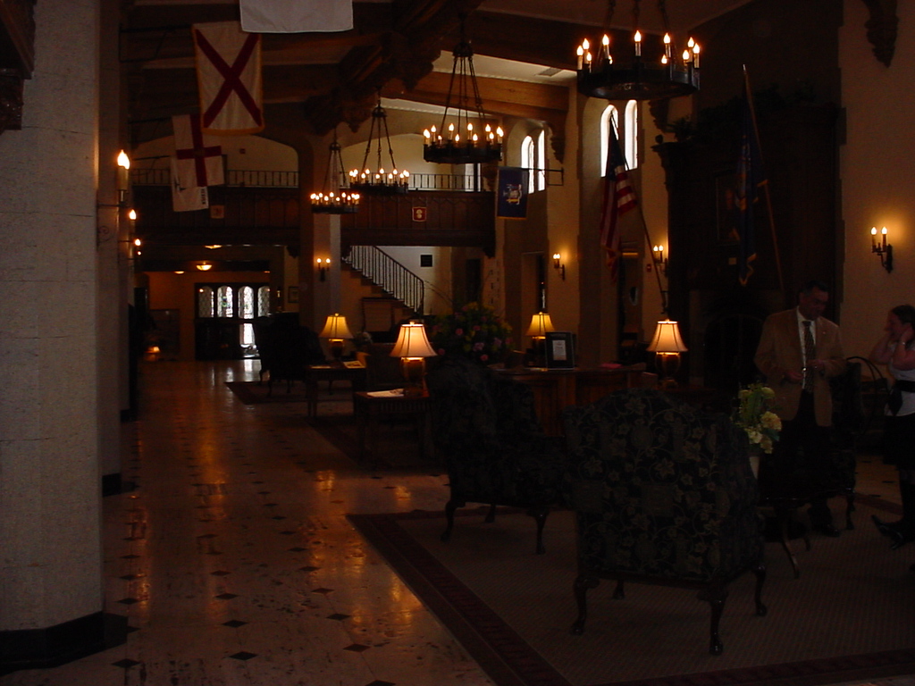 a lobby decorated with candles, chairs and flowers