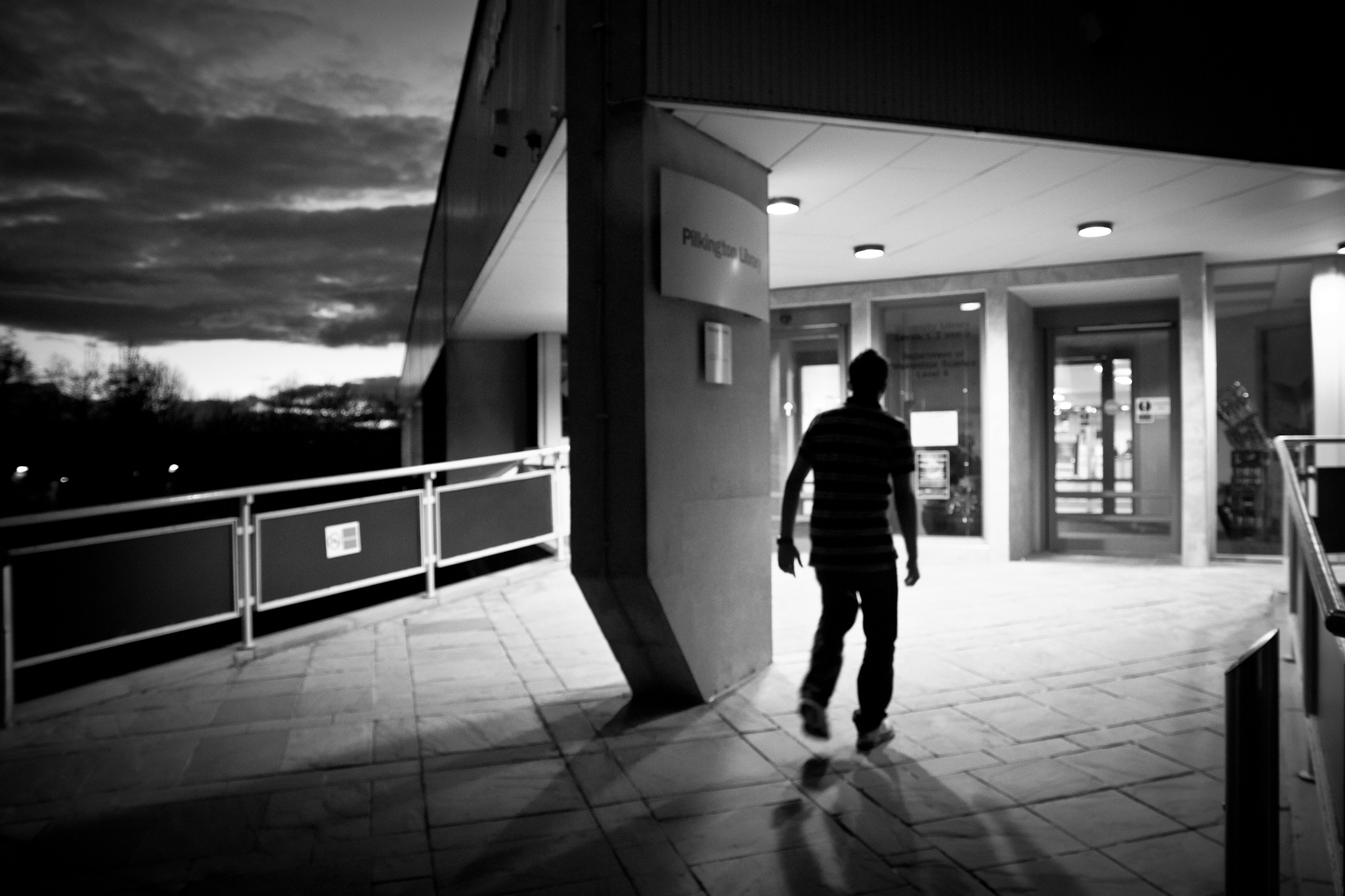 a person walking down a street past two doors