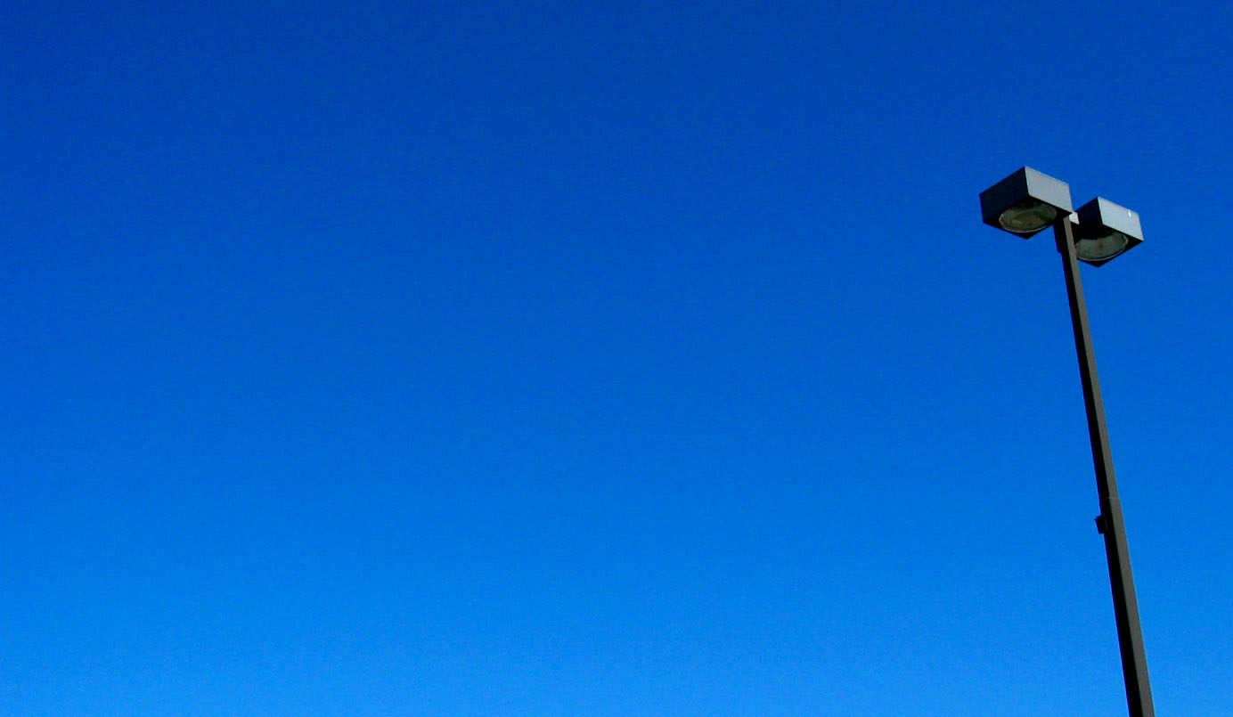 a light pole and blue sky background