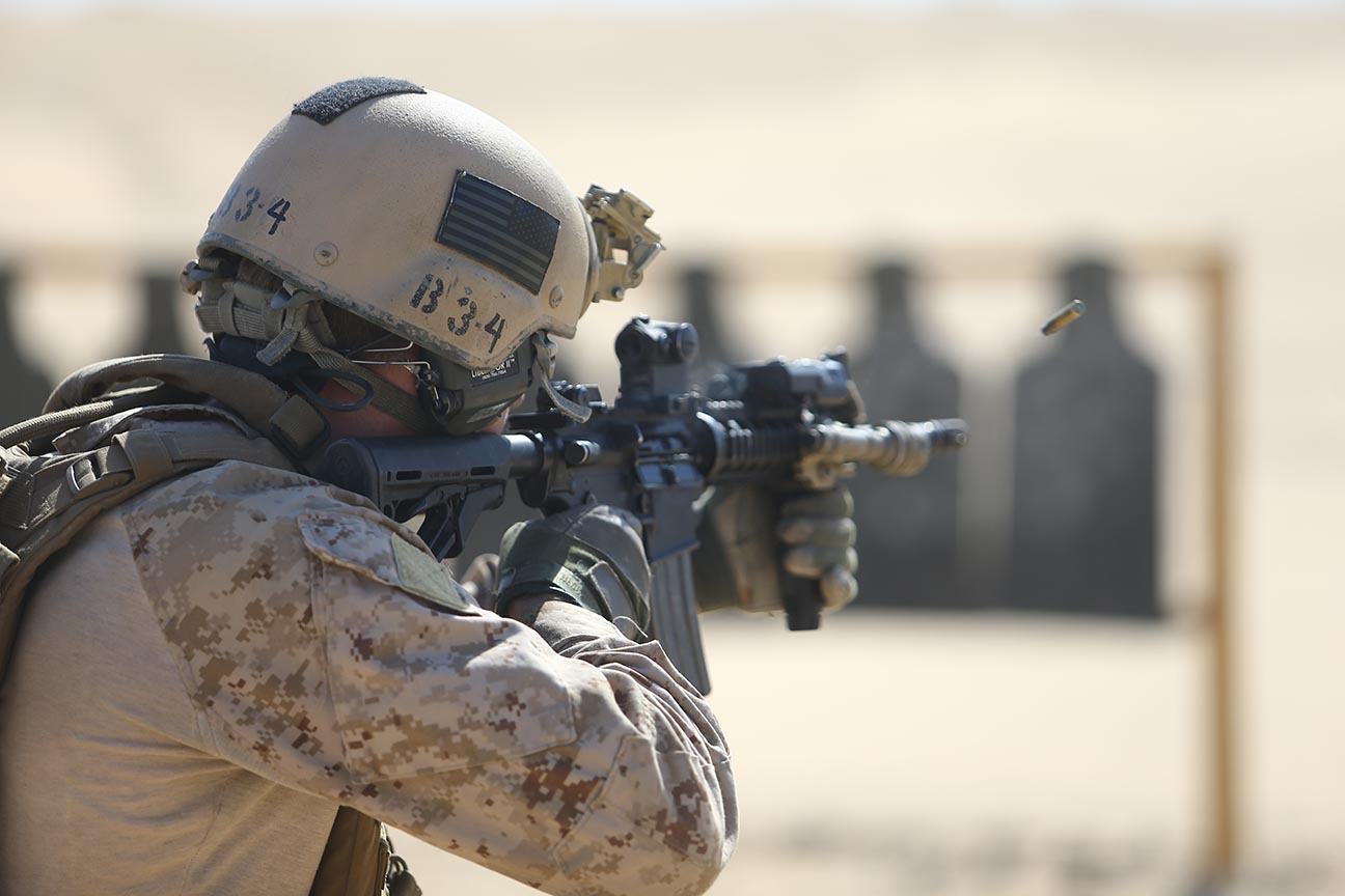 a man is holding a gun and shooting