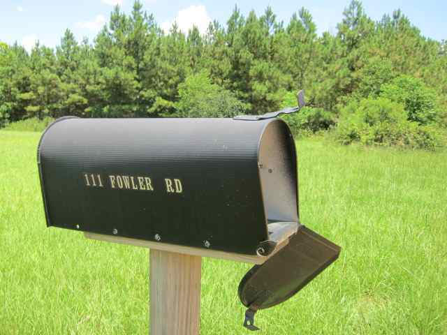 an old mailbox with a broken roof and missing cover