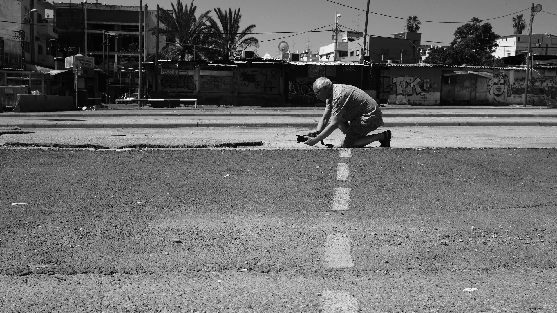 a man is kneeling down next to a street