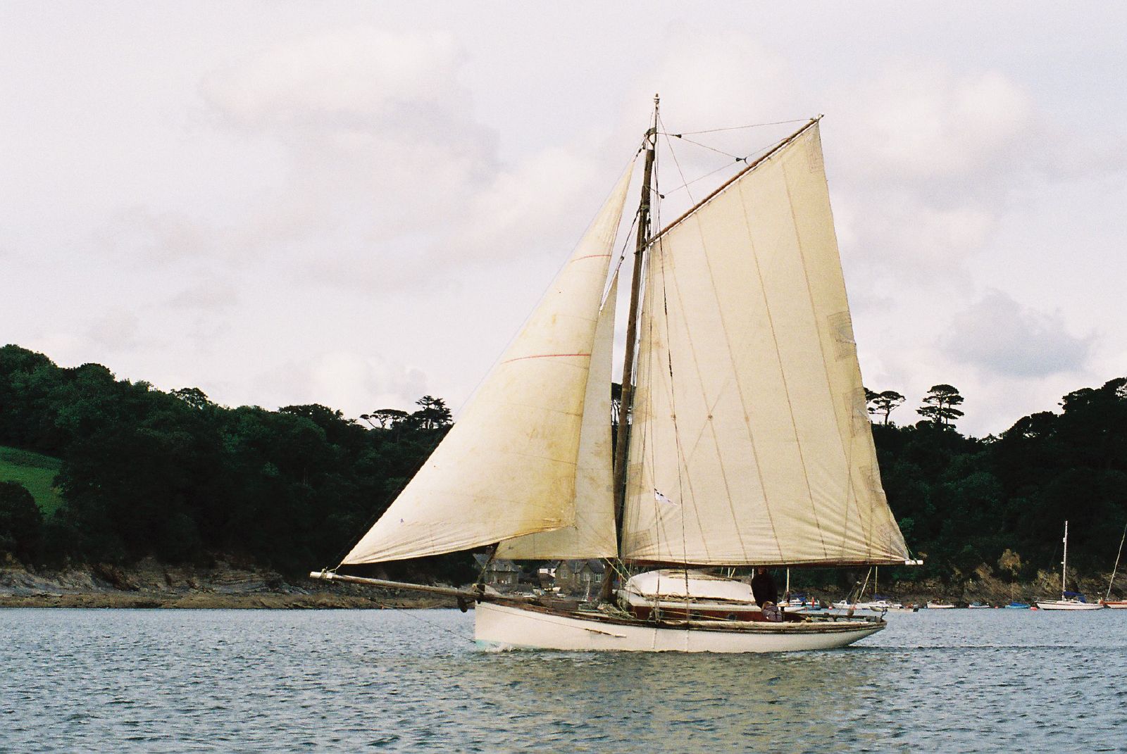 a sail boat is sailing in the open water