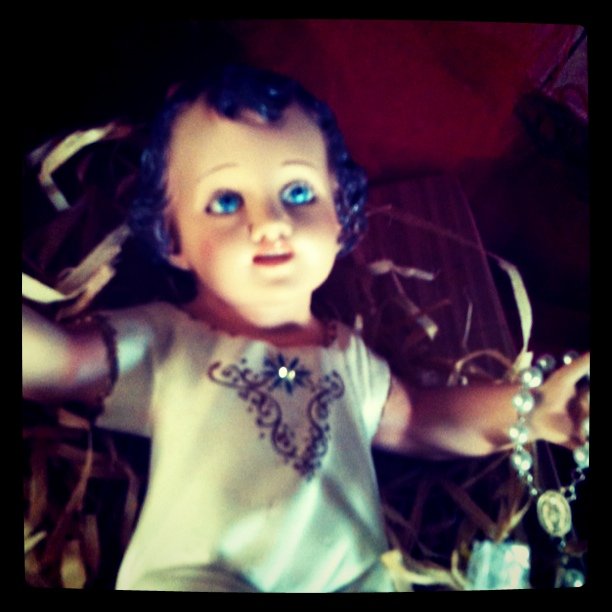 a creepy doll with blue eyes and purple hair
