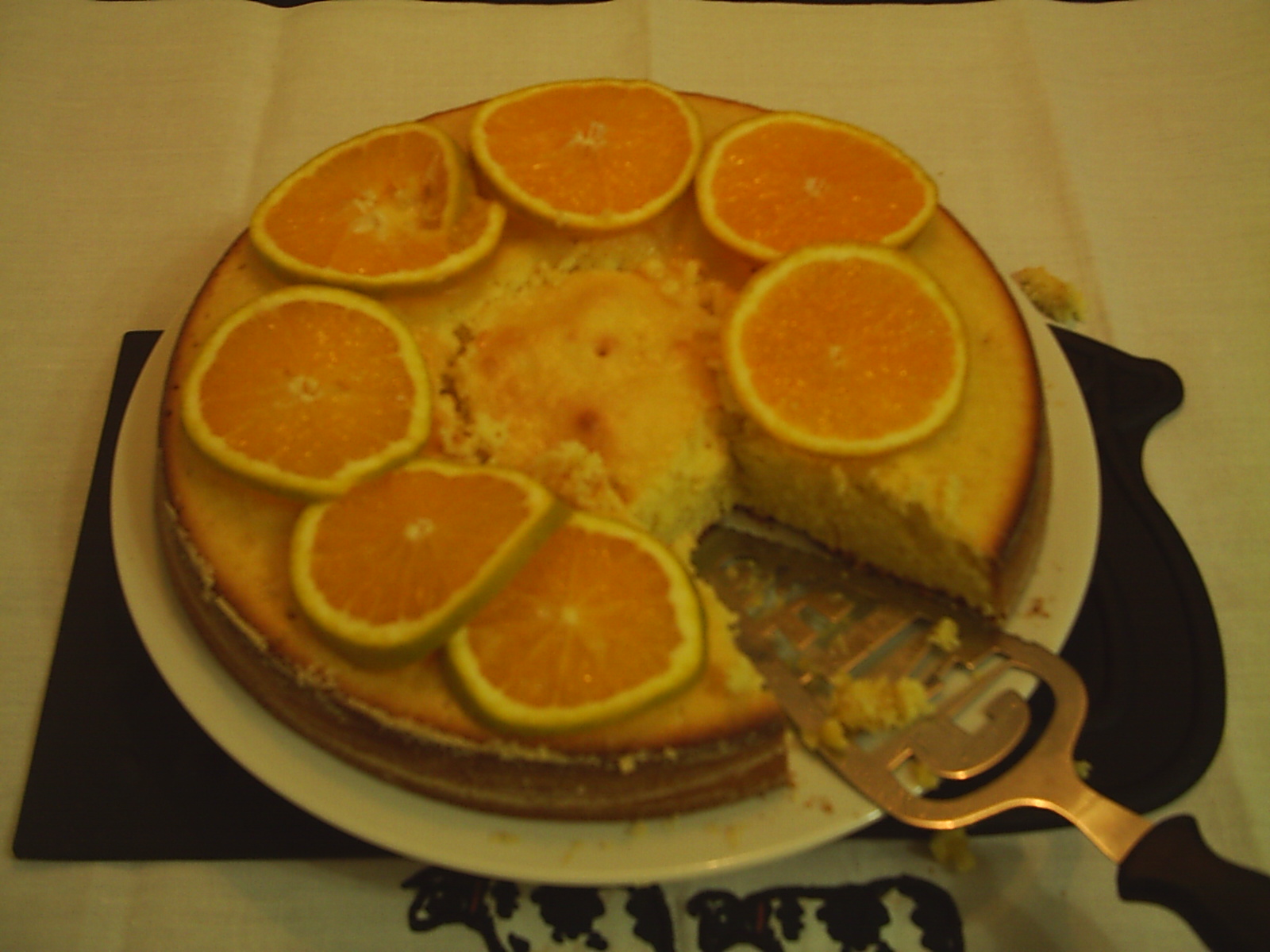 an orange and cheese cake with slices cut out