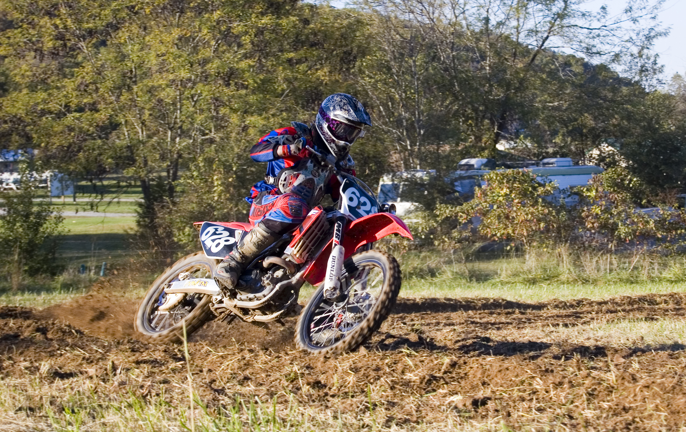 the motorcross biker is turning on some muddy road