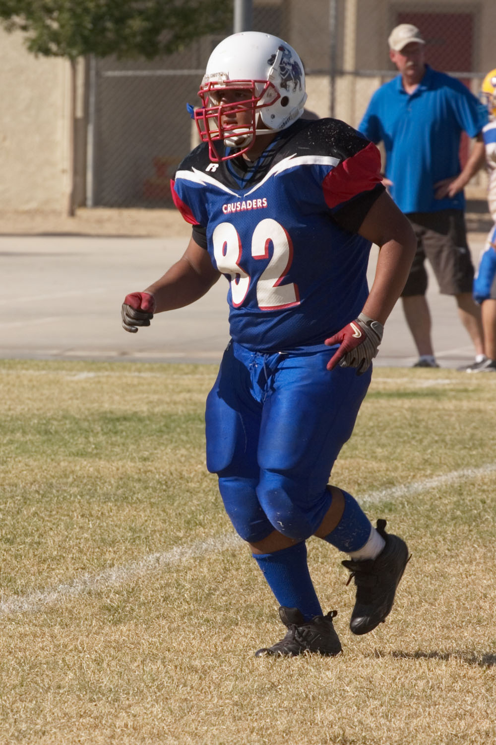 a player running and looking to the side during a football game
