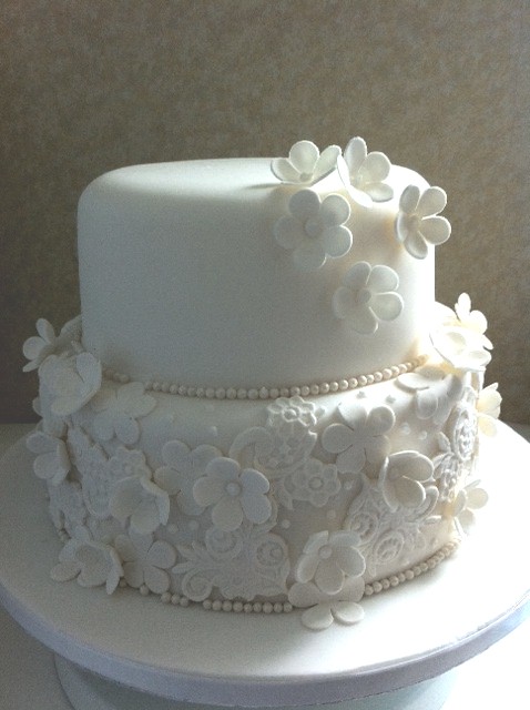 the white wedding cake has flowers on it