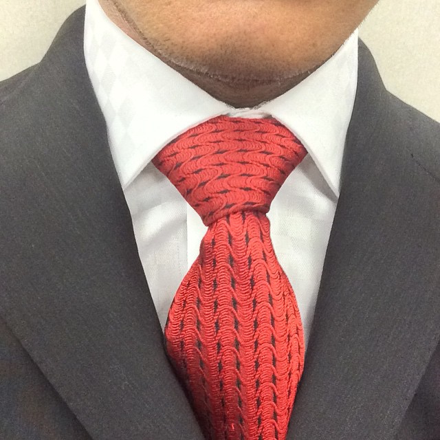 the man's tie has been worn with a suit