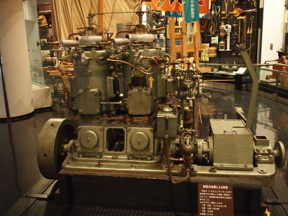 large steam engine on display in museum with signs