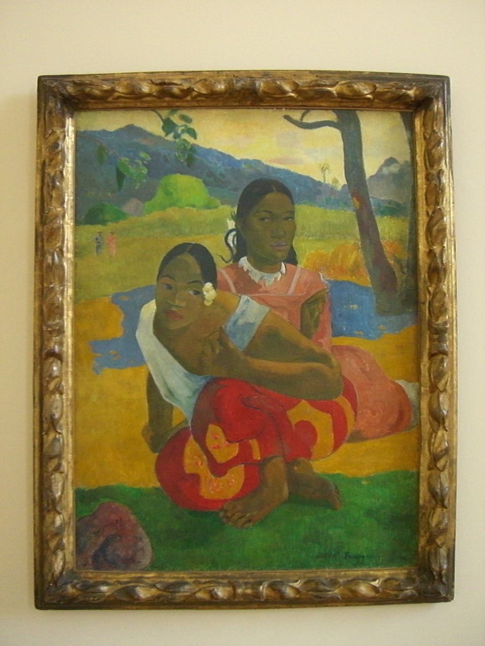a painting hangs on a wall of two black women