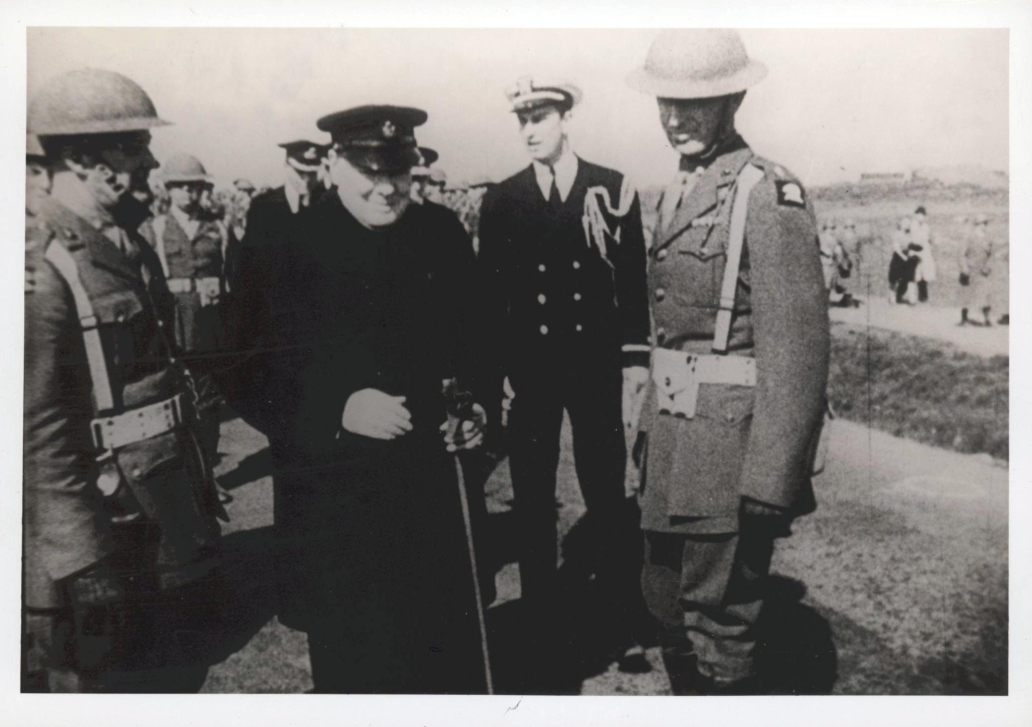 a woman in a uniform standing between two men wearing medals