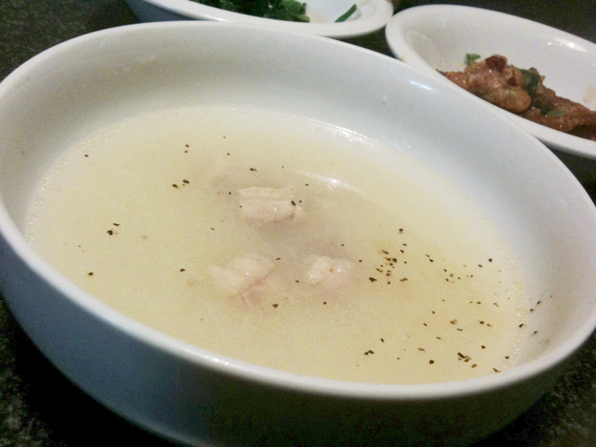 two bowls filled with soup on top of a table