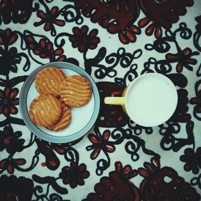 a bowl and bowl with cookies next to a glass on a plate