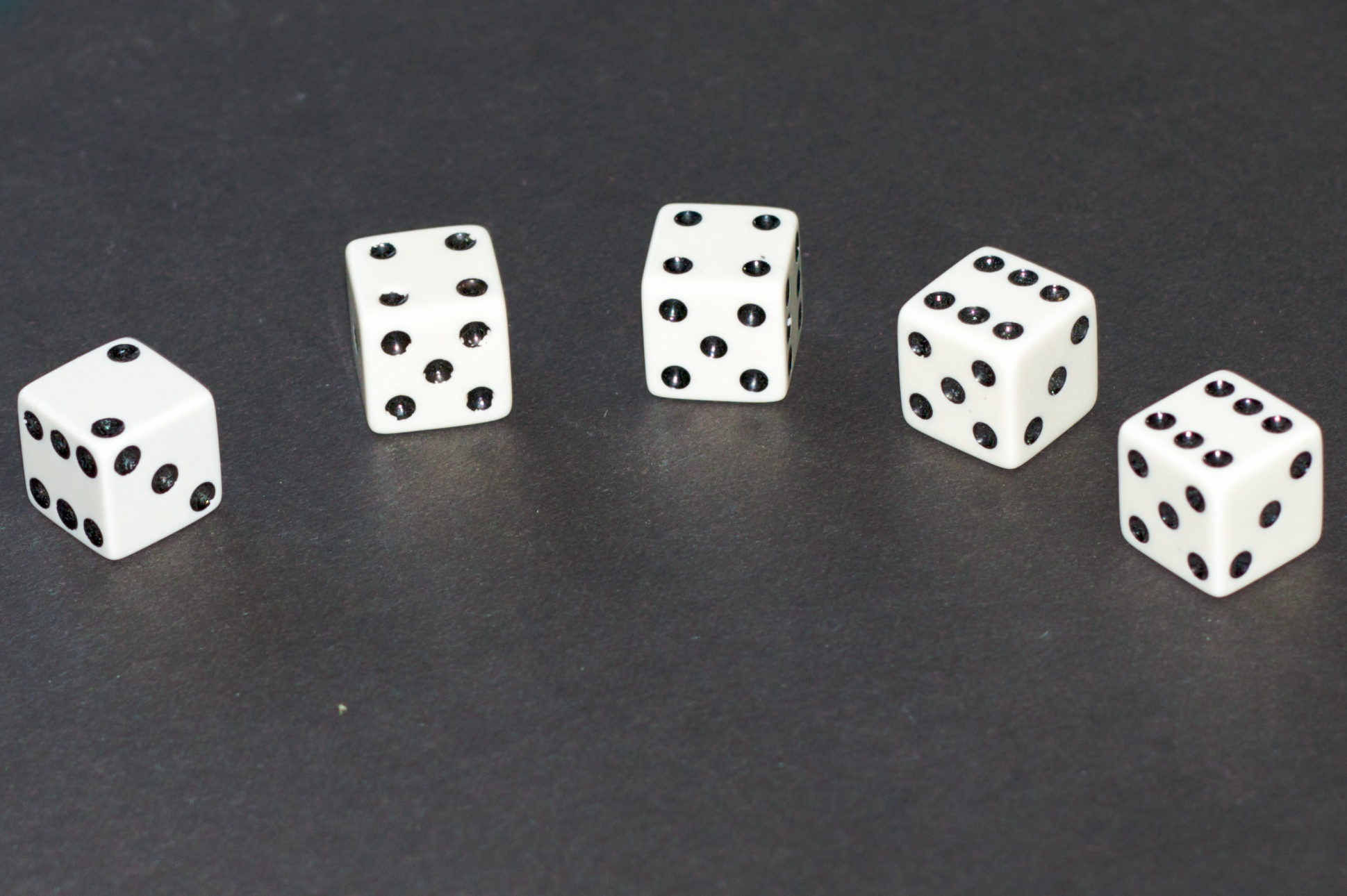 a group of five dices laying on a table