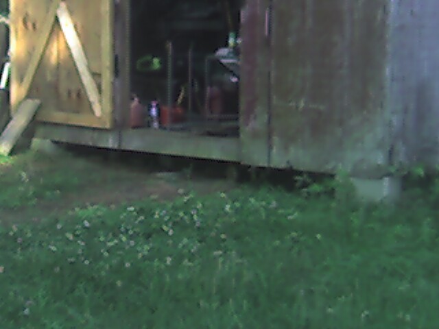 there is a small object inside of the back of the shed