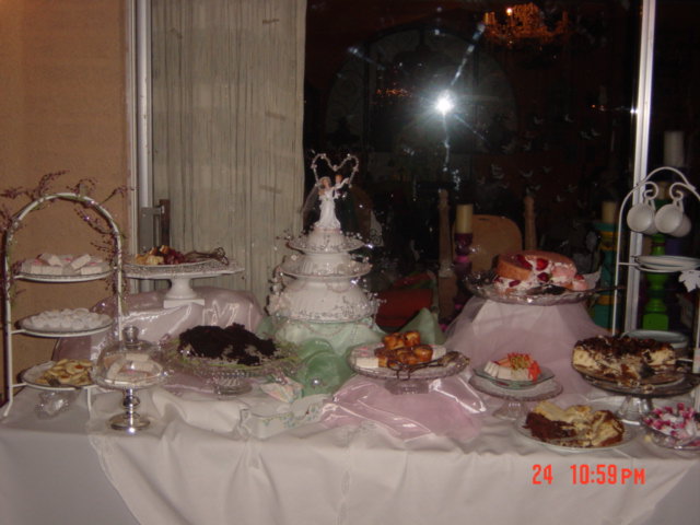 a table filled with assorted pastries and cakes