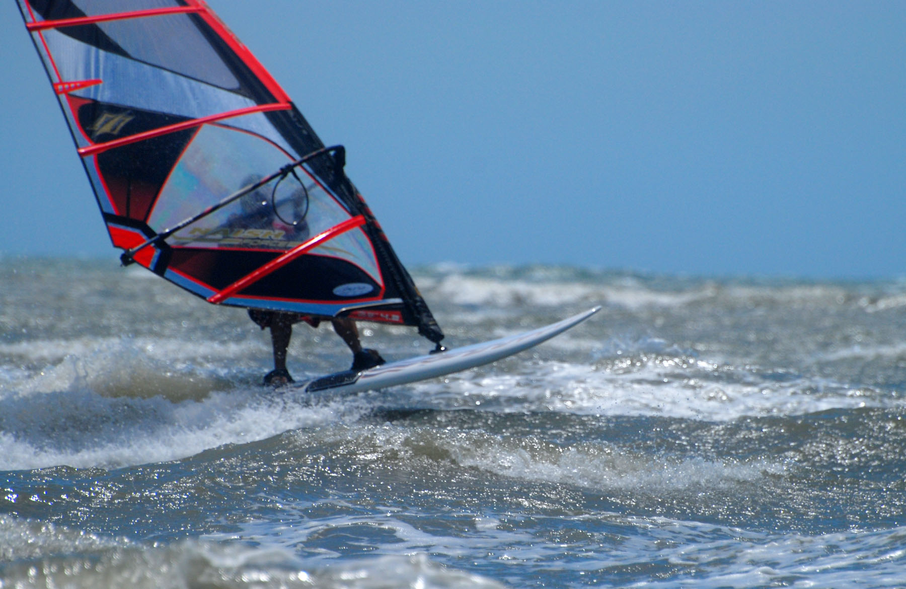 a windsurfer in the ocean riding the waves