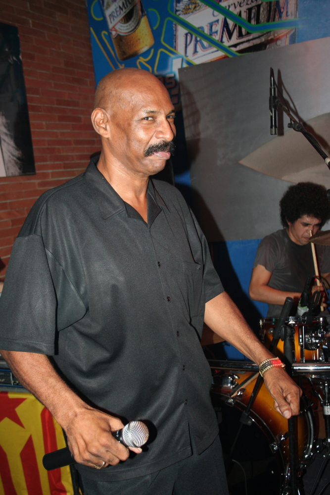 a man standing in front of a drum set