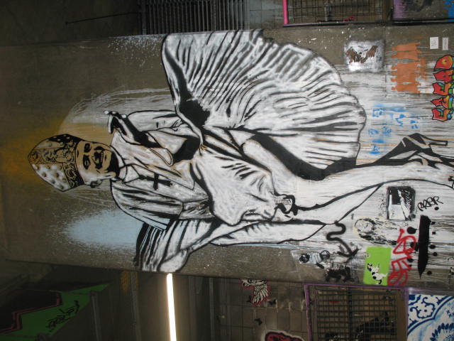 a wall mural depicting a man in ballet clothes holding a dance skirt