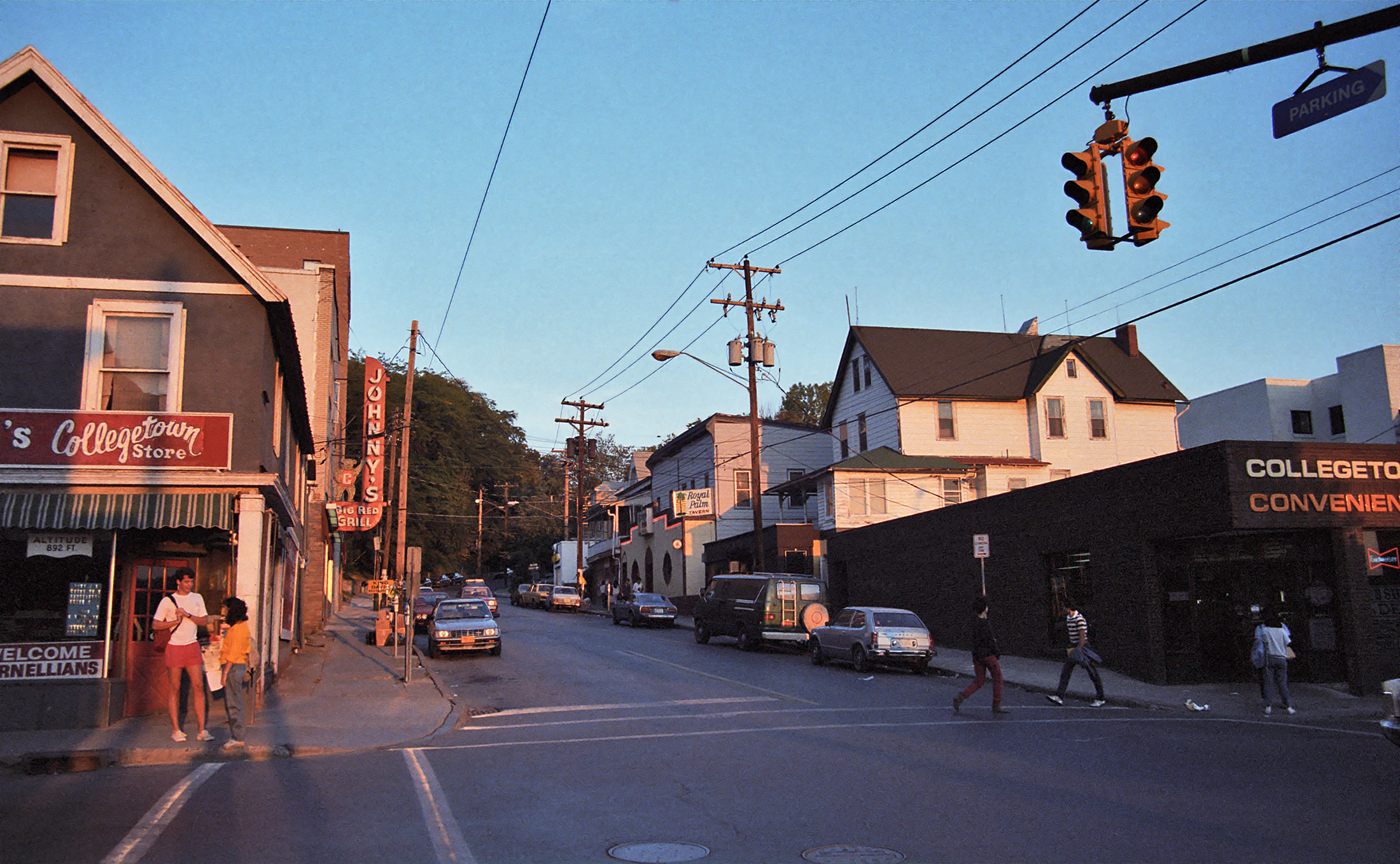 an intersection is pictured as people are walking through the neighborhood