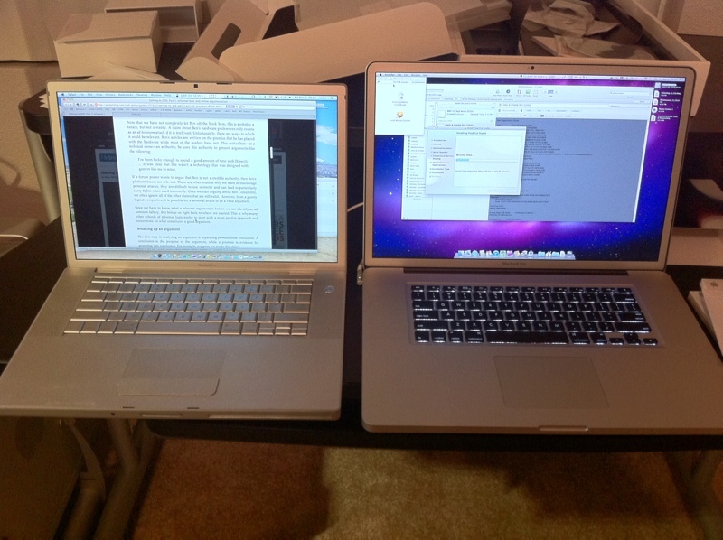 two laptops sitting next to each other on a table