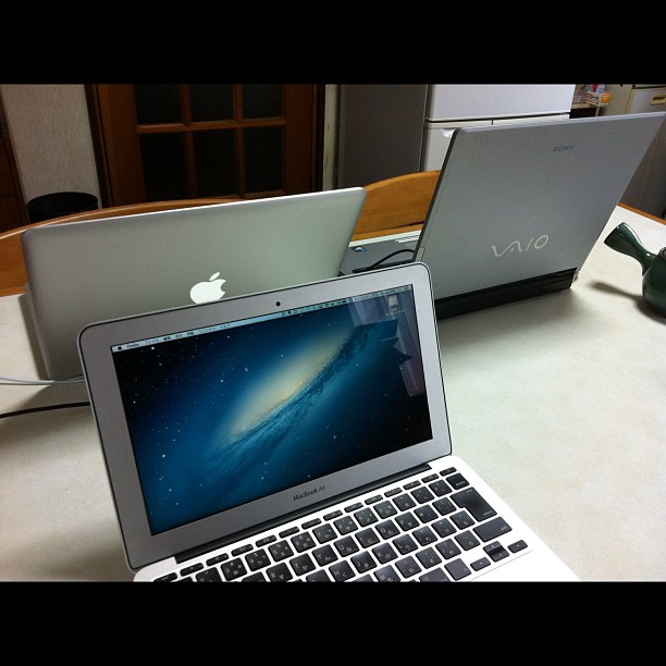 there are two lap tops sitting on the table