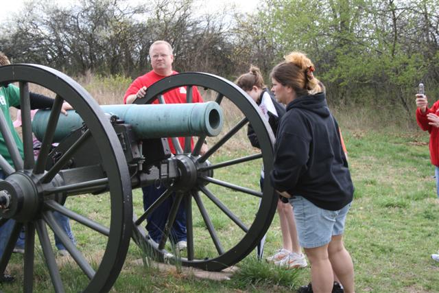 some people are standing around a cannon