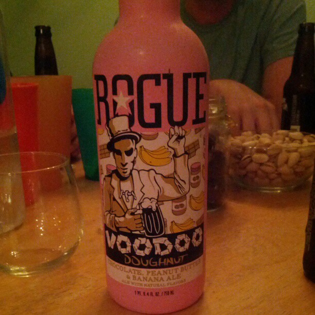 a pink bottle sitting on top of a wooden table
