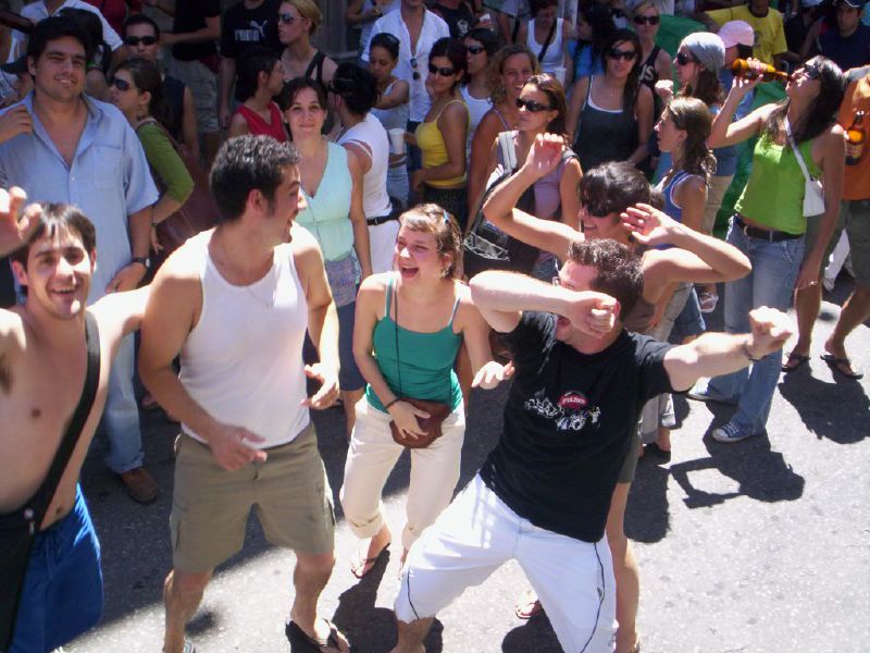 people standing around and dancing in the street
