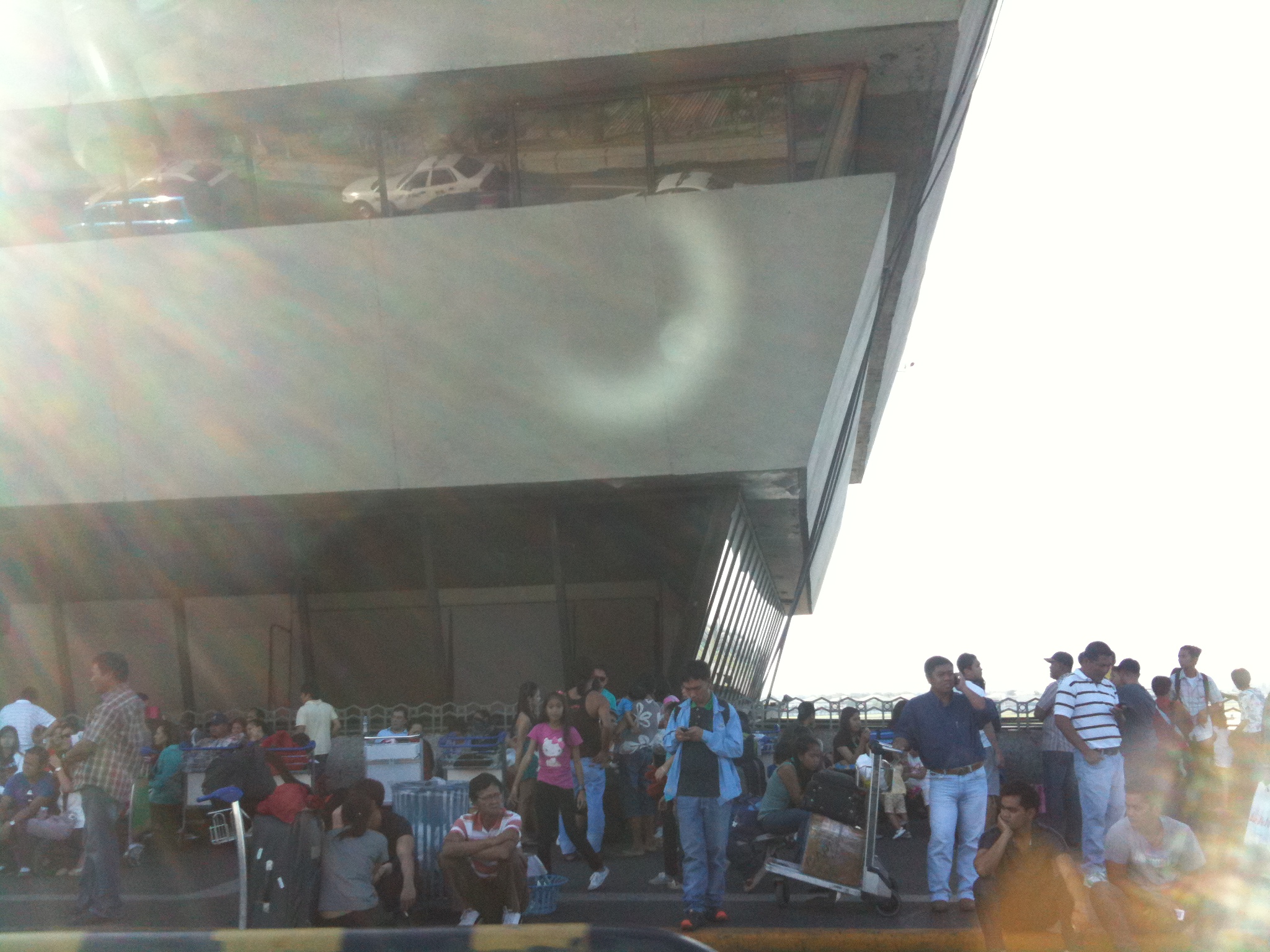 many people on the street waiting for their luggage