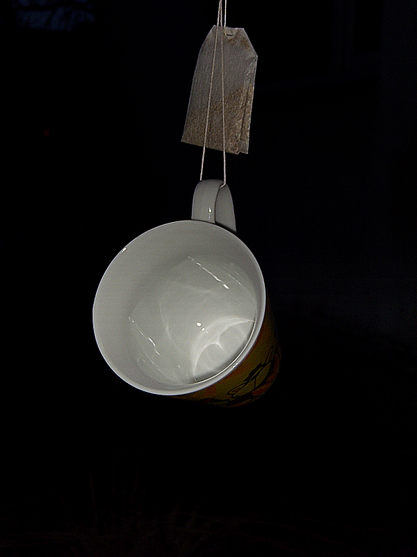 a bowl hanging from the ceiling in the dark