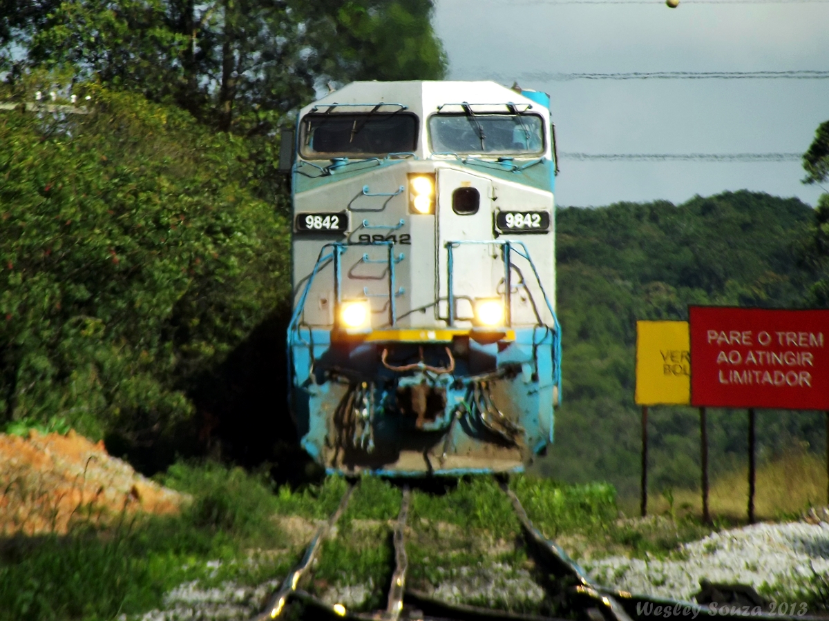 a train engine hauling carts down the tracks