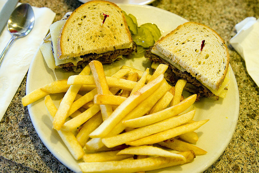 two slices of a sandwich on a plate with french fries