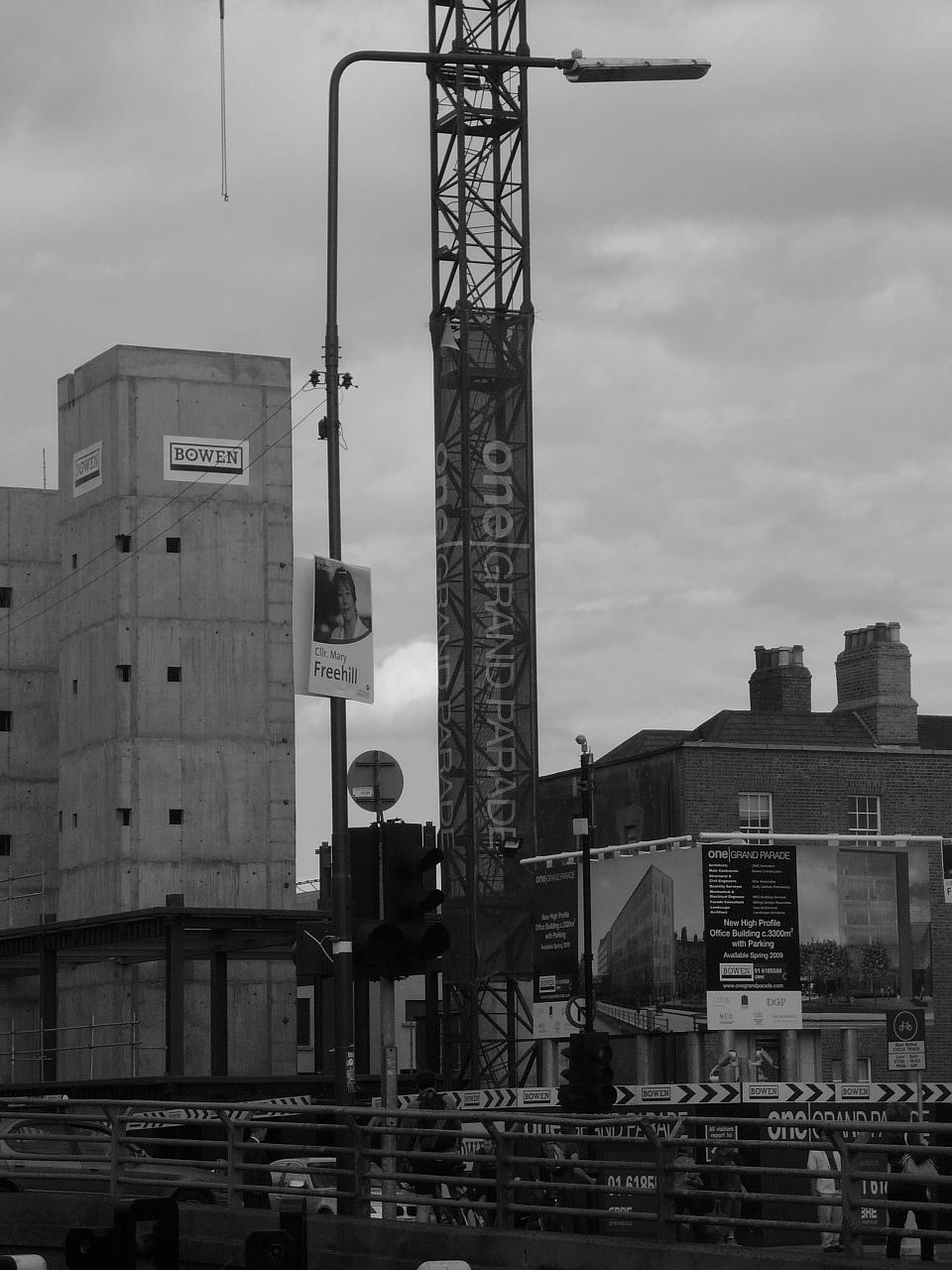 some cars and a large crane with no people