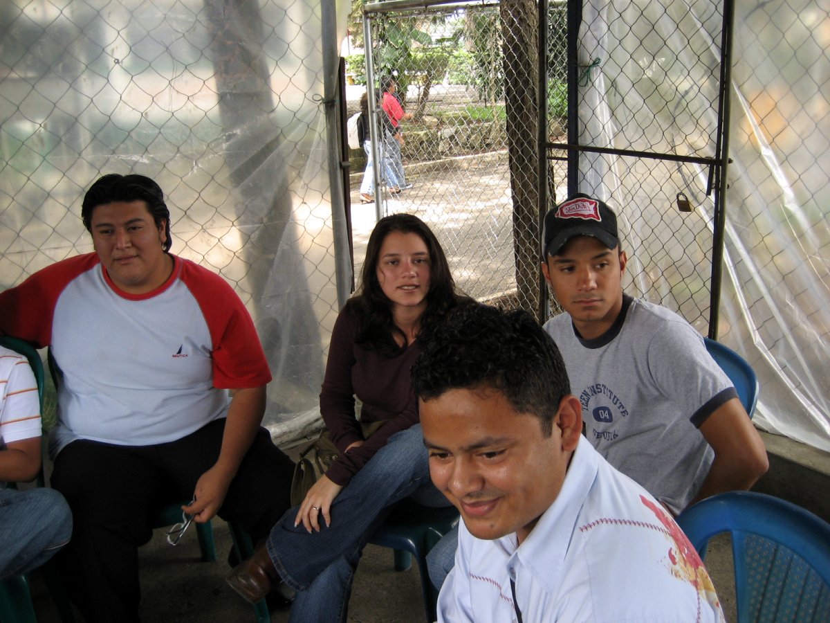 a man sitting in a chair with several others around him