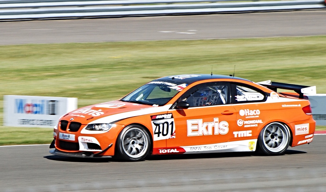 an orange race car speeding along the track