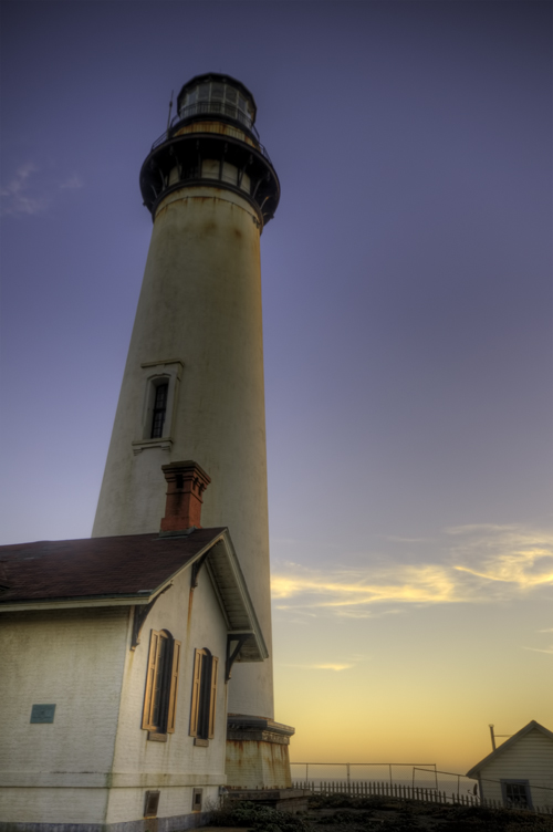 the lighthouse is at dusk by itself, it was so dark